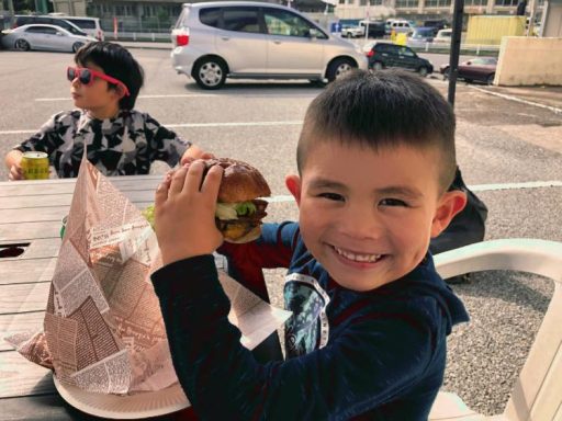 Japanese child eating a hamburger